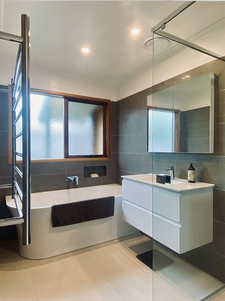 Marble tile shower recess by Kat's Plumbing